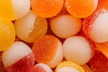 Macro photo multi-colored marmalade jelly candy's. Dessert marmalade in the form of lemon and orange slices. The sweetness of jelly candy yellow and orange. Copy space