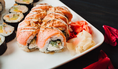 Set of sushi with wasabi, soy sauce on black stone slate background