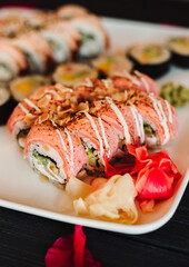 Set of sushi with wasabi, soy sauce on black stone slate background