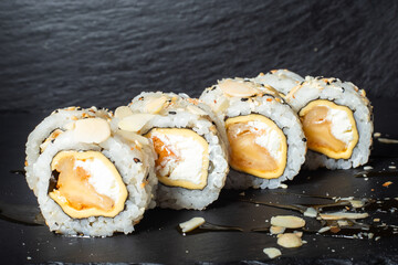 Set of sushi with wasabi, soy sauce on black stone slate background