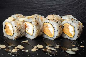 Set of sushi with wasabi, soy sauce on black stone slate background