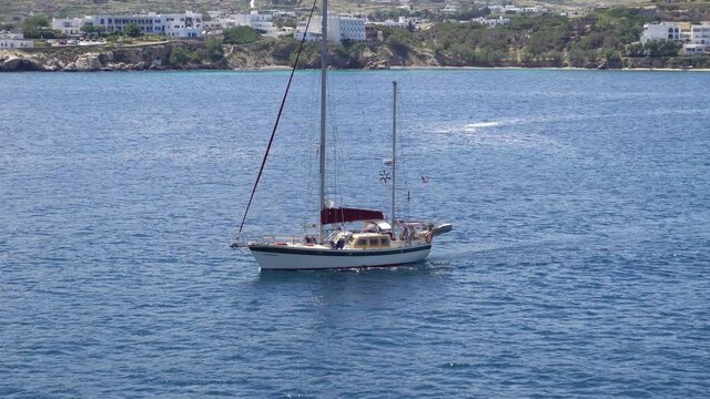 Sail boat sailing along Paros island, Greece, aerial shot