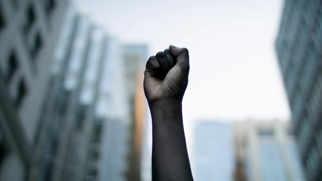 Raised black man's fist in protest. Social justice and peaceful protesting racial injustice. Shot in 4k.