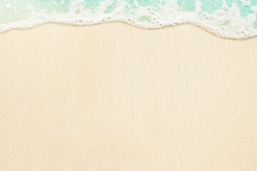 Fototapeta na wymiar Ocean wave on the sand. Summer beach background with copy space