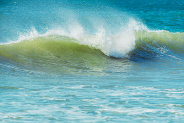 Sea wave closing with splash and foam. Blue ocean water surface background