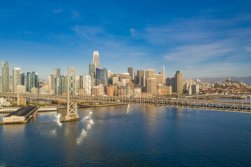 Fototapeta premium Aerial view of the San Francisco, California, skyline at sunrise. Ample copy space in blue sky. Bay bridge in foreground.
