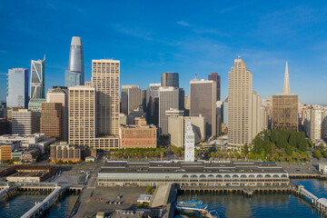 Fototapeta na wymiar Aerial daytime view of the Embarcadero of the San Francisco, California, skyline. Ferry building in the foreground, ample copy space in blue sky. Morning light.