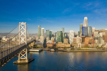 Fototapeta na wymiar Aerial view of the San Francisco, California, skyline at sunrise. Ample copy space in blue sky. Bay bridge in foreground.