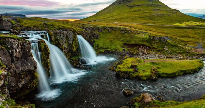 Iceland time lapse video of waterfall and famous mountain. Kirkjufellsfoss and Kirkjufell in northern Iceland nature landscape. Amazing timelapse photography in 4K HDR.