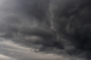 Fototapeta premium Dark contrasting cloudy rainy sky, clouds thicken, background