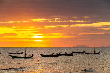 silhouette of fishing boats at sunset