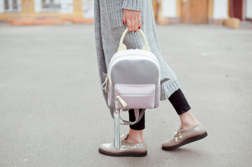 Fashion woman with colorful backpack on the city street . Street style . 