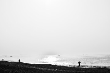 A beach landscape / silhouette of  fisherman.