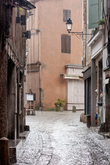 Street of an ancient european city in the rain