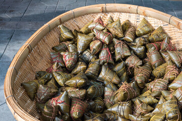 Heap of ZhongZi - traditional Chinese rice dish made of glutinous rice stuffed and wrapped in bamboo leaves in a street market, Chengdu, Sichuan province, China