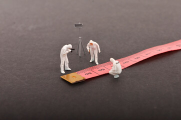 Miniature people ; the figure of a Crime Scene Investigation. Selective focus.