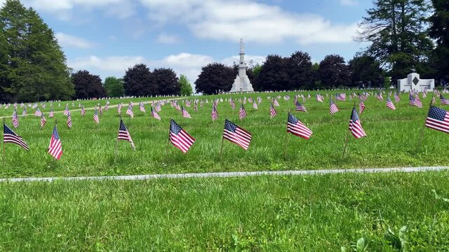 American flags adorn graves of Civil War National Cemetery in Gettysburg PA, army veterans buried, patriotic fallen soldiers