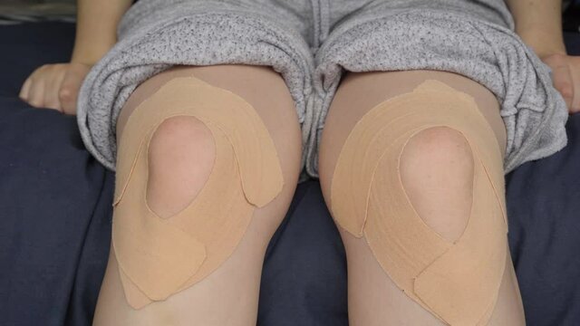 Young woman's legs moving and showing her kinesthetic bandages.