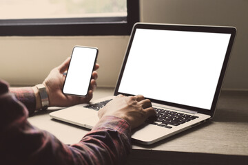 computer,cell phone mockup image.hand woman work using laptop texting mobile.blank screen with white background for advertising,contact business search information on desk in cafe.marketing,design