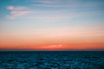 A hazy view of the sunrise over the sea