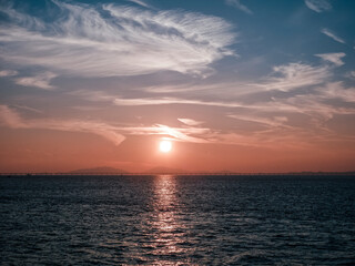 A hazy view of the sunrise over the sea