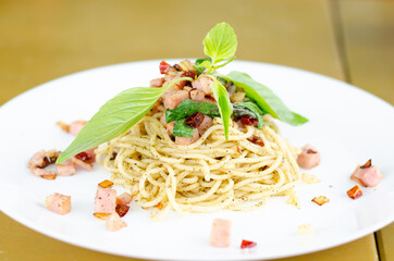 Stir-Fried Spicy Spaghetti bacon ham in a White Plate.