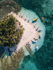 Aerial photos of Guyam Island, a tear-drop shaped island in the Philippine Sea situated around 2 kilometres south-southeast of General Luna municipality. Popular stop for tourists doing island-hopping © Jonathan