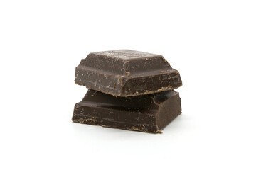 Broken black chocolate bar isolated on white background