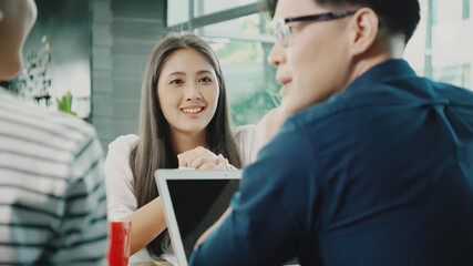 Happy Business woman asian sitting in meeting with Team Business people to work happy with smile In modern office. New normal working agreement. Talking and consultation between colleague