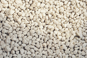 white pebbles stone texture background. Naturally polished white rock pebbles background