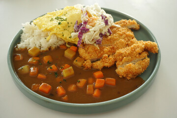 Chicken katsu curry on a green plate