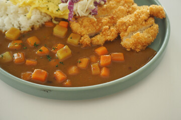 Chicken katsu curry on a green plate