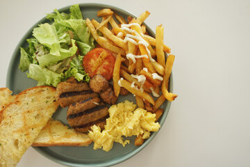 Close up of english breakfast on a green plate.
