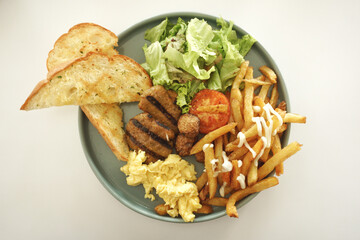 Close up of english breakfast on a green plate.