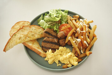 Close up of english breakfast on a green plate.