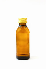 Amber glass bottle of energy drink with gold cap isolated on white background