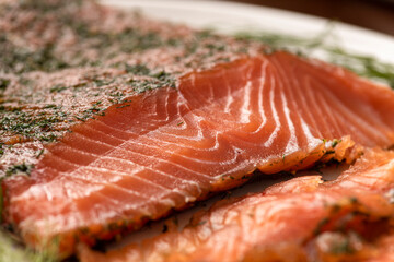 dried smoked salmon gravlax with dill on a white platter close up macro