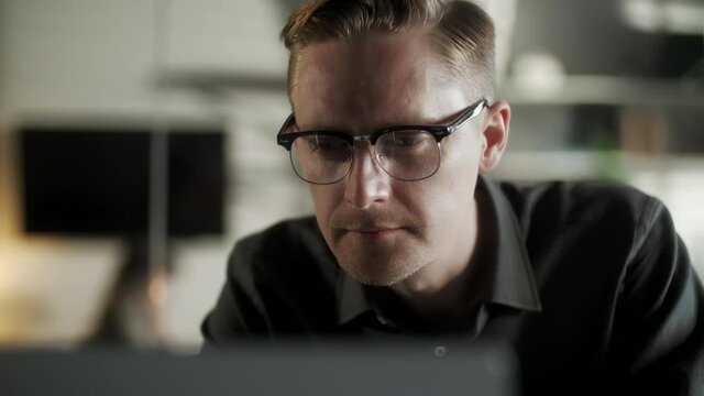 Young Man Freelancer Using Laptop Online Working From Office In Internet, Smiling Focused Millennial Guy Searching On Computer Surfing Web Looking At Screen Enjoying Distant Job