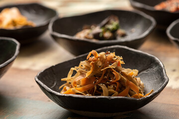 asian fermented kimchi fermented food cabbage on a black bowl and other ingredients on background
