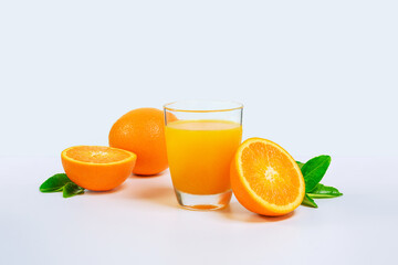 Orange juice and two orange slices and green leaves isolated on white background. Glass of orange juice.
