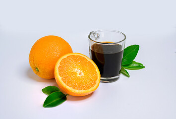 Orange slice with fresh orange and hot coffee and green leaf isolated on white background.