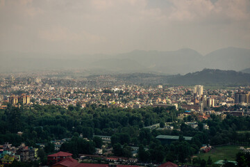 Obraz premium View to big city Kathmandu surrounded by mountains from the hill