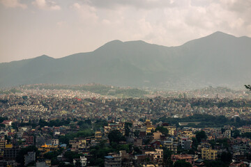 Fototapeta na wymiar View to big city Kathmandu surrounded by mountains from the hill