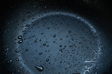 oil drops on black pan background