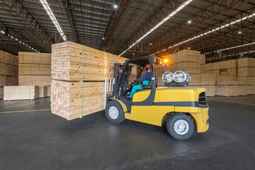 wood pallet forklift driving at a factory floor inside a shed © zequinao