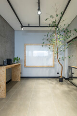 interior design of a office with osb furniture coffee table notes board and tree glass wall and cement