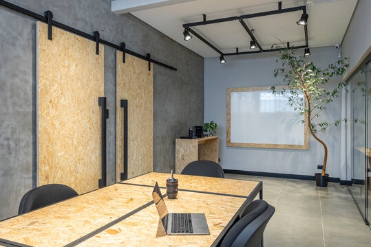interior design of a office with notebook osb table and sliding doors