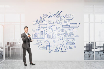 Asian man with coffee in office, business plan