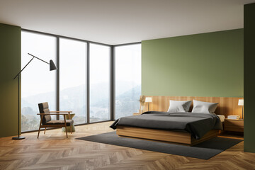 Green master bedroom corner with armchair
