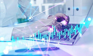 Woman hands typing on laptop, financial chart